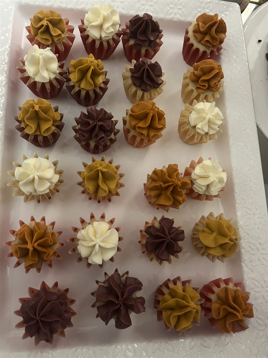 Assorted mini cupcakes in warm colors